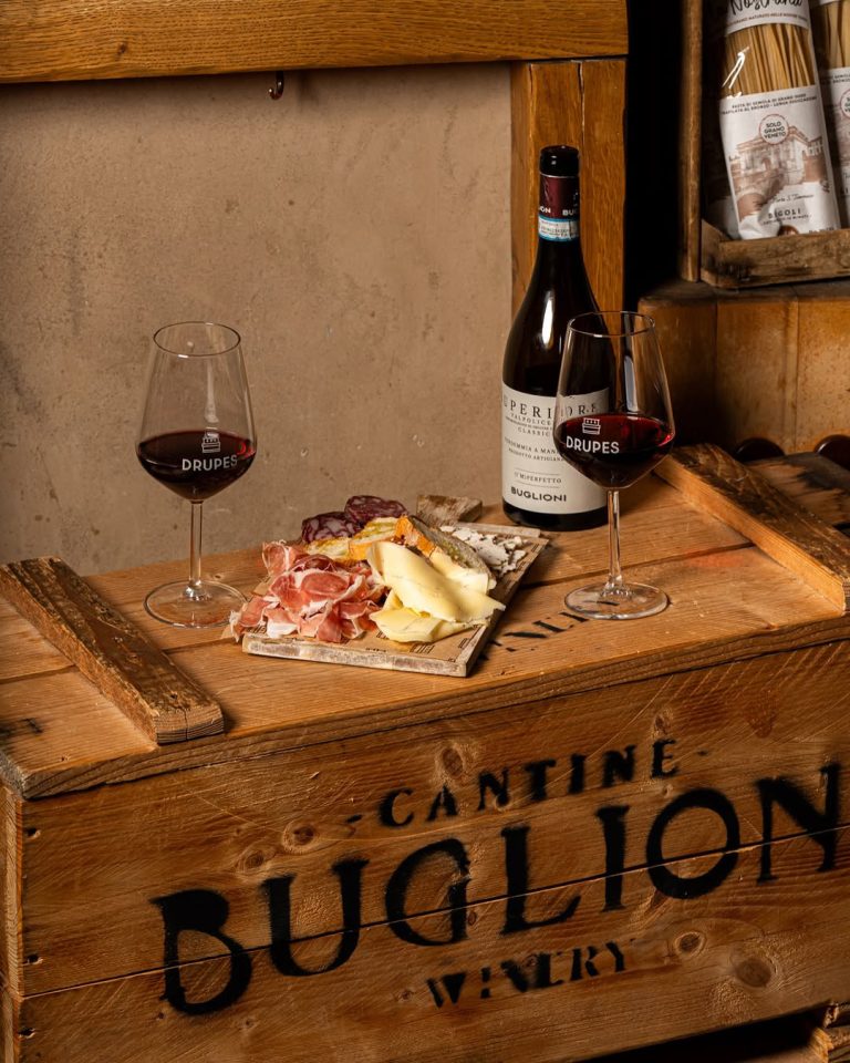 Wooden platter of Greek and Italian delicacies with spritz cocktails at Drupes & Drips, Athens.