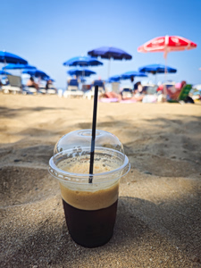 The beloved freddo espresso in its characteristic plastic cup; the perfect beach companion on a hot day.