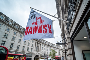Banksy Plants a New Flag — Right Over His Own Head