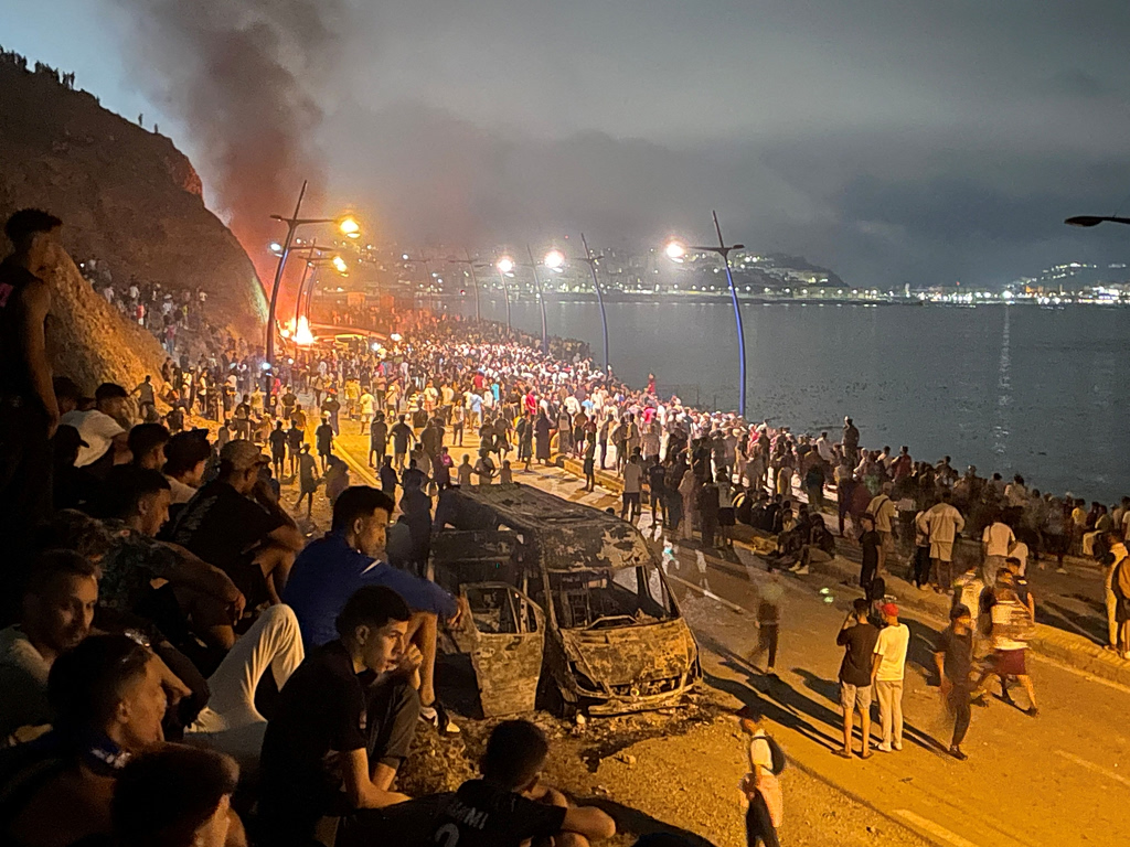 Spain's Interior Ministry estimated on Friday that around 49,000 migrants crossed into the Spanish enclave of Ceuta in North Africa over the previous 24 hours, as people attempted to enter from Morocco by sea and land.A spokesperson for Spain's Guardia Civil border police said migrants were "massively entering from the sea" through the Tarajal breakwater but could not provide an estimate of the number of people involved. More migrants were reported to have crossed into Ceuta overnight, with Spanish media reporting alleged "passivity" by Moroccan police during the influx. In response, the Spanish government said it was deploying additional troops and police officers to reinforce security at the border between the small Spanish territory and neighboring Morocco. Spanish Prime Minister Pedro Sánchez was expected to visit Ceuta later on Friday. The sudden increase in arrivals also triggered a dispute within the European Union, after Italian officials called for Spain to be suspended from the Schengen open-border area until it regained control of the situation. Italian Prime Minister Giorgia Meloni, in a rare direct clash between two EU countries, said images from Ceuta showed that "uncontrolled illegal immigration poses a concrete threat to the security of Europe's borders." "Italy will not stand by and watch. … We are prepared to intervene with extraordinary measures to defend the borders and the safety of citizens, including the suspension of the Schengen Area with Spain," Meloni said. Italian Foreign Minister Antonio Tajani backed the proposal, saying he supported suspending Spain from the Schengen area and linking the migration crisis to Spain's recent decision to regularize more than 500,000 undocumented migrants living in the country. Spanish Foreign Minister José Manuel Albares criticized the Italian remarks, calling them "unbecoming of a foreign minister of a partner and friendly country" and dismissing them as "partisan demagoguery." He said he would summon the Italian ambassador to Madrid on Friday. Albares instead pointed to a recent Spanish Supreme Court decision, which ruled that migrants intercepted at sea while attempting to reach Ceuta or Melilla could not be immediately returned under the enclaves' special border rejection system. Ceuta, a Spanish enclave on the northern coast of Africa bordering Morocco, has long been a key route for migrants seeking entry into European territory.